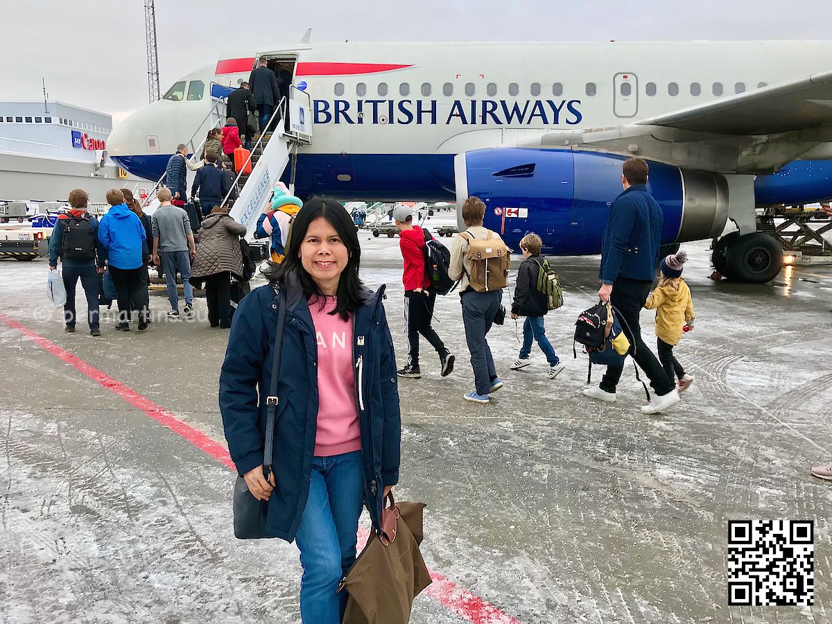 British Airways plane on the ground woman standing in front of it