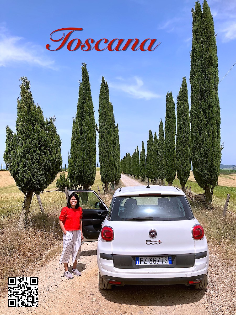 Italy Tuscany woman near rental car Fiat 500 in an alley with trees 