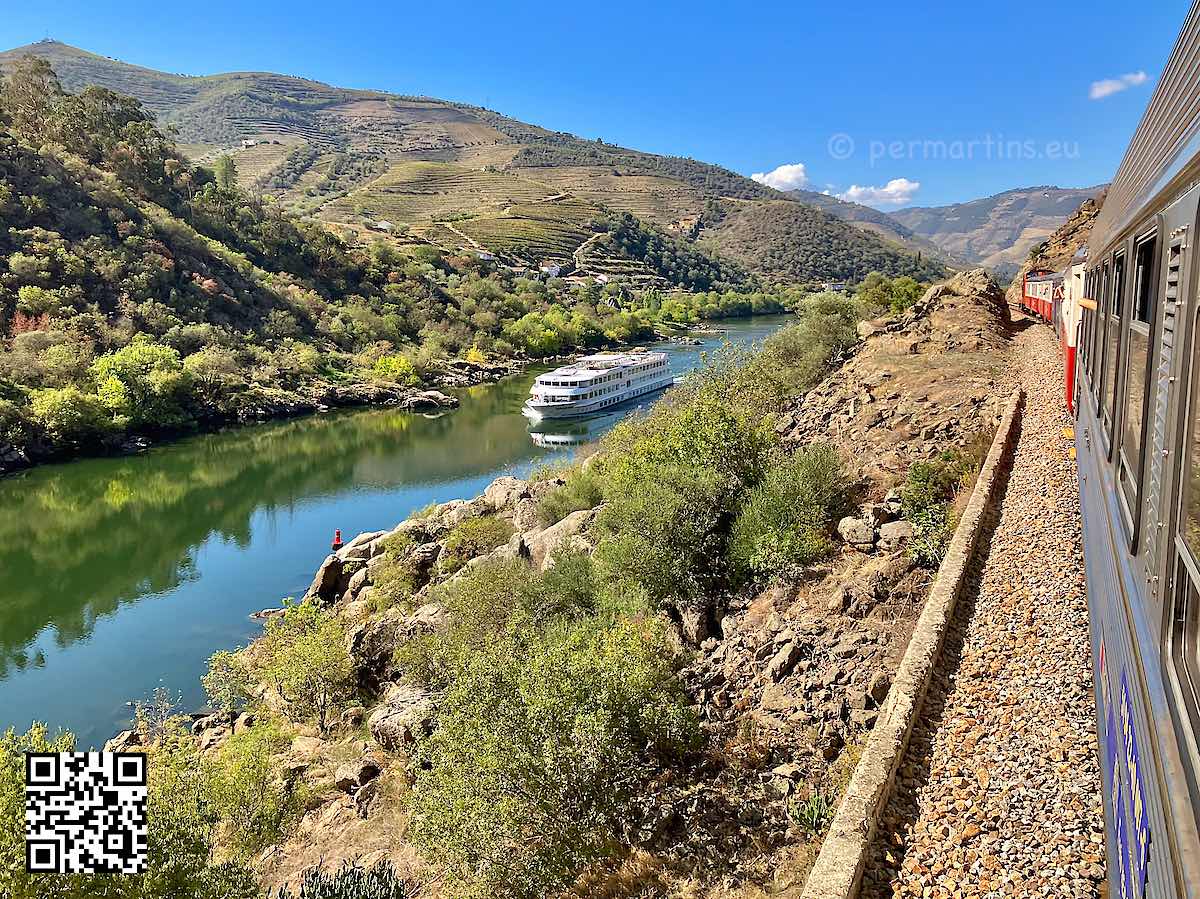 Portugal photo from train over the Douro river with a boat going upstreams