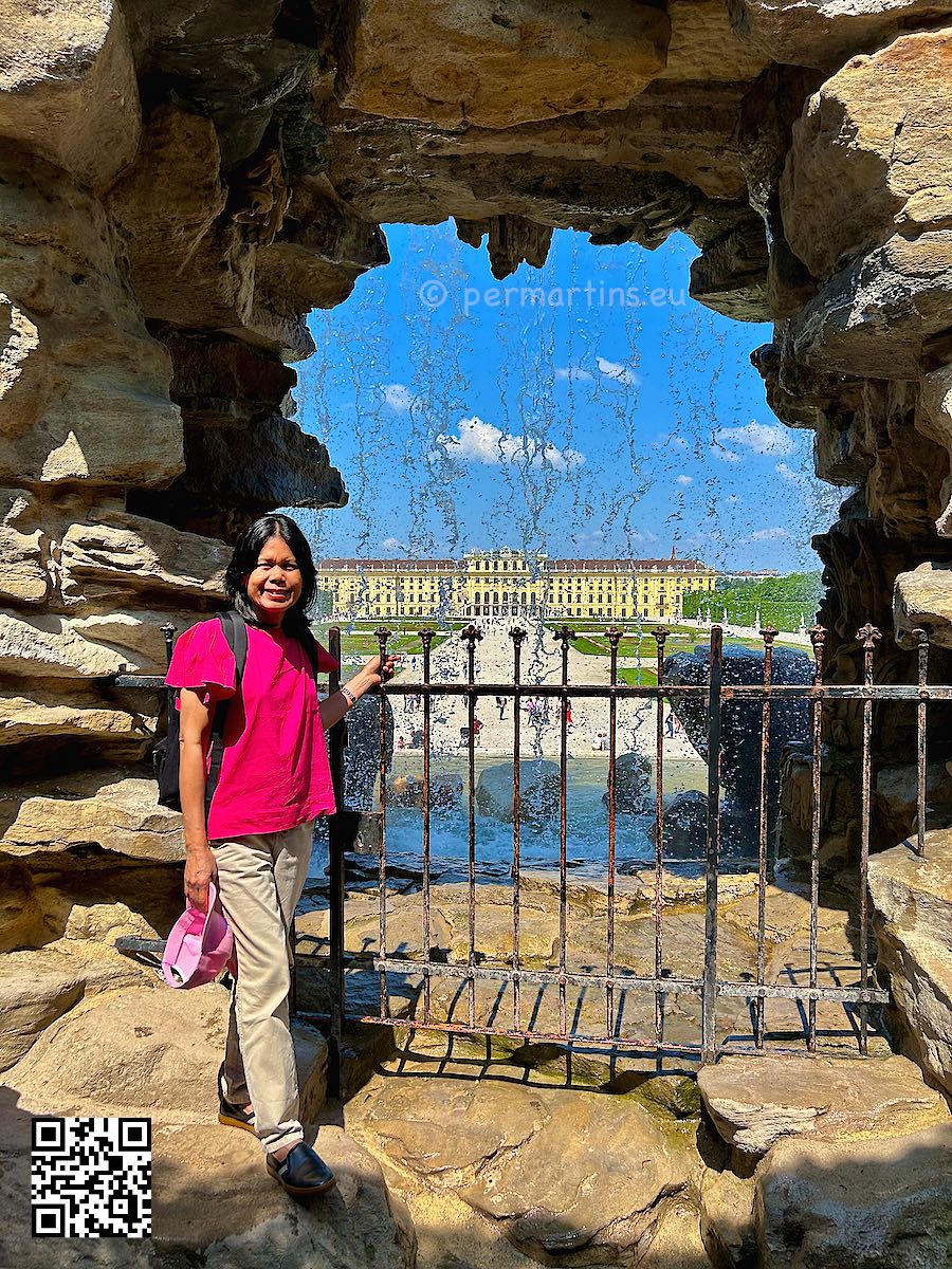Austria Vienna Schönbrunn woman standing near a waterfall at Neptune Fountain Neptunbrunnen