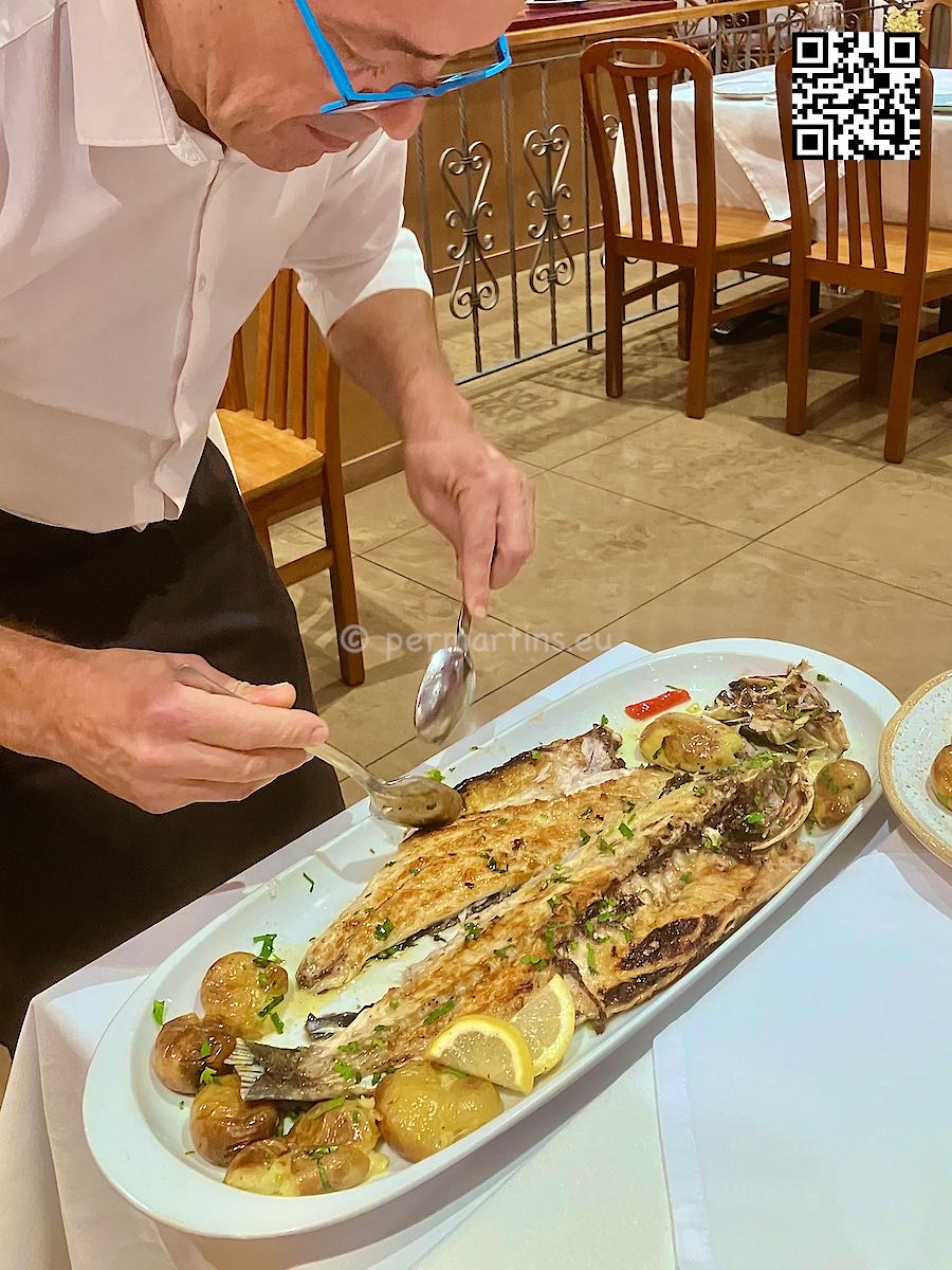 Portugal Coimbra serving fish at Restaurante Solar do Bacalhau
