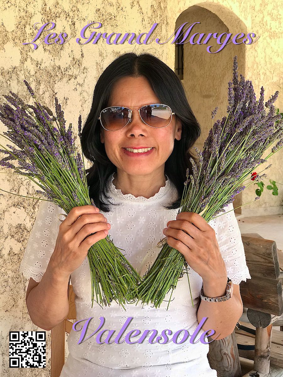 France Provence Valensole at Les Grand Marges lavender shop & café woman holding lavender in her hands