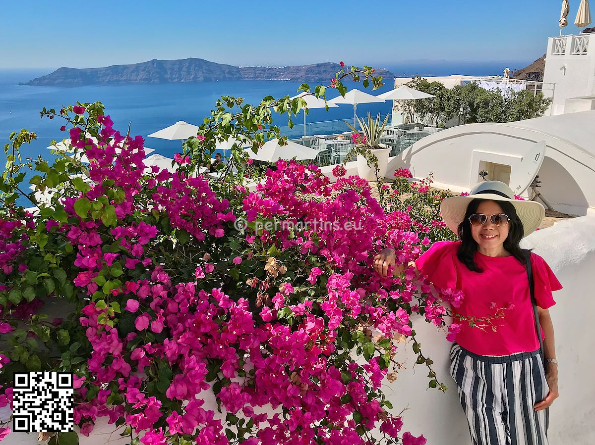 Greece Santorini Firostefani Villa Fegari woman next to Bougainvillea flowers