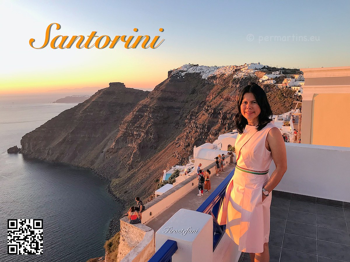 Greece Santorini Firostefani woman looking out over the caldera steep walls of the volcano