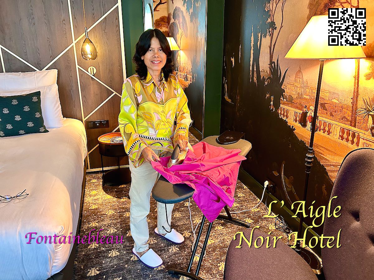 France Fontainblau woman ironing clothes in a suite at Hotel L´Aigle Noir 