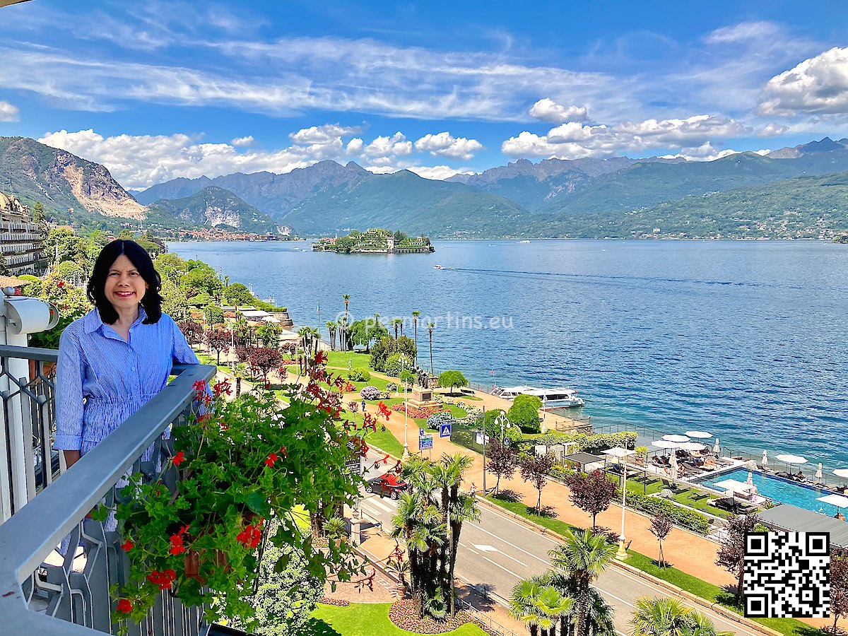 Italy Stresa view over Lago Maggiore from Hotel Astoria woman on balcony