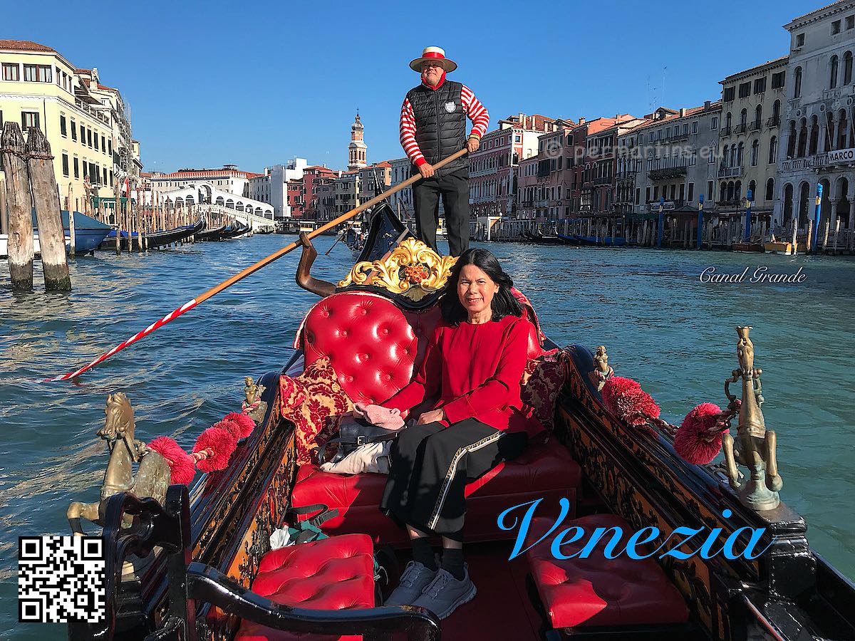 Italy Venice woman in a gondola on Canal Grande gondolier Ponte Rialto