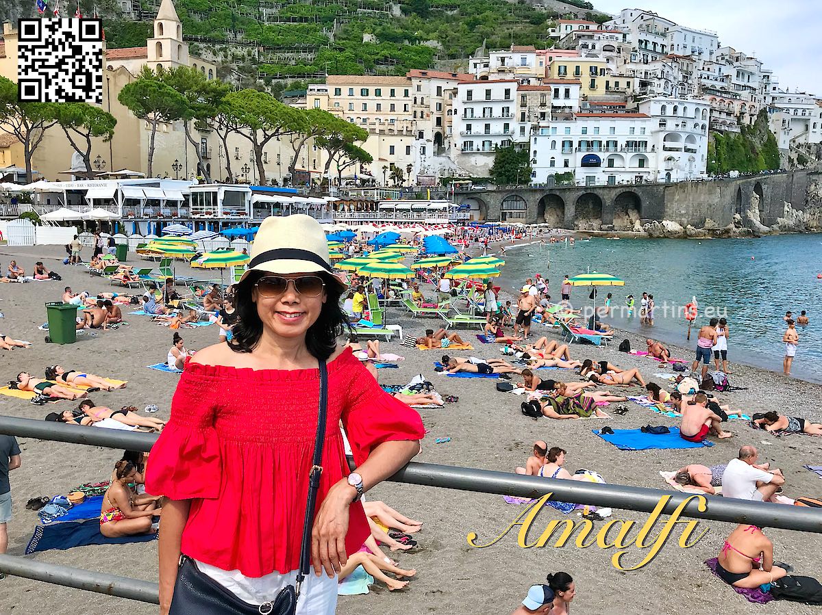 Italy Amalfi woman with hat beach behind her