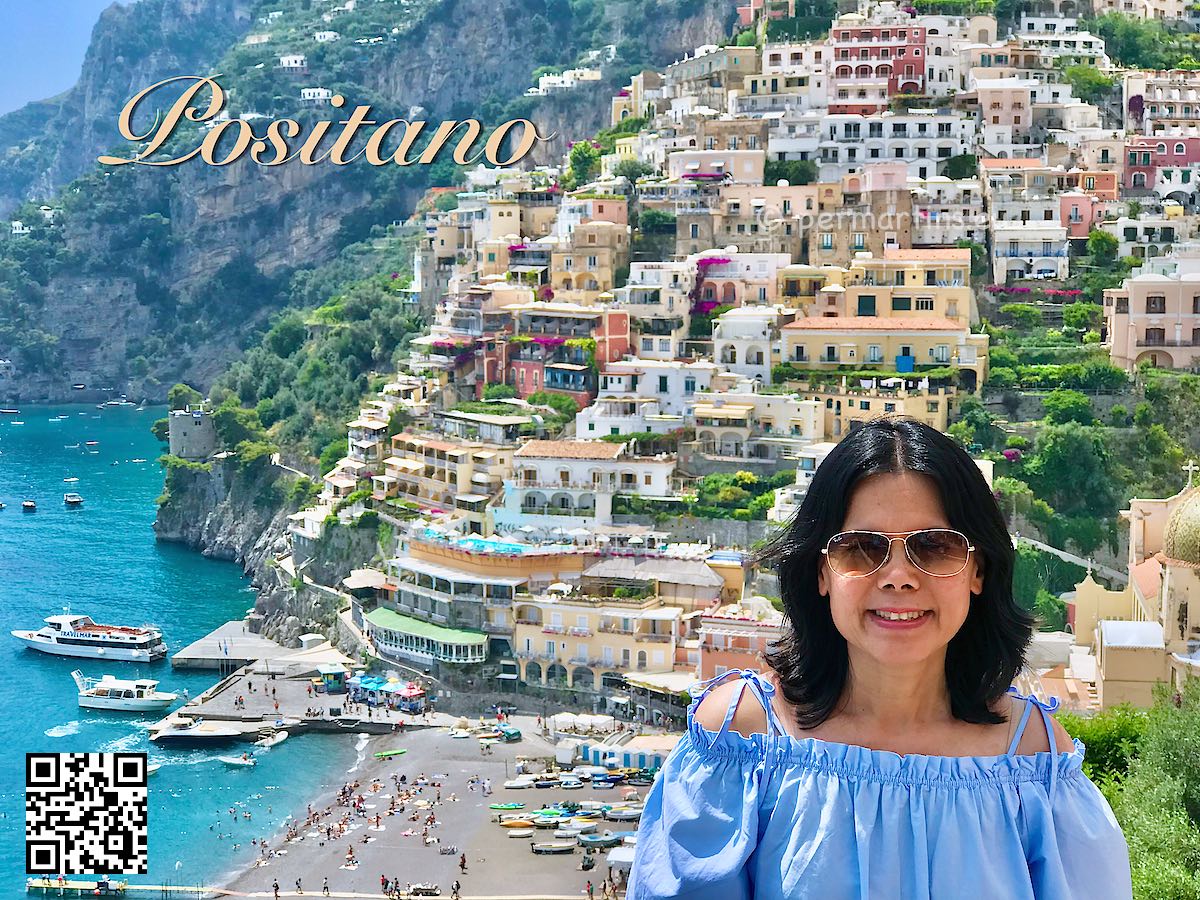 Italy Positano women in blue and sunglasses with a view over Positano houses beach and port
