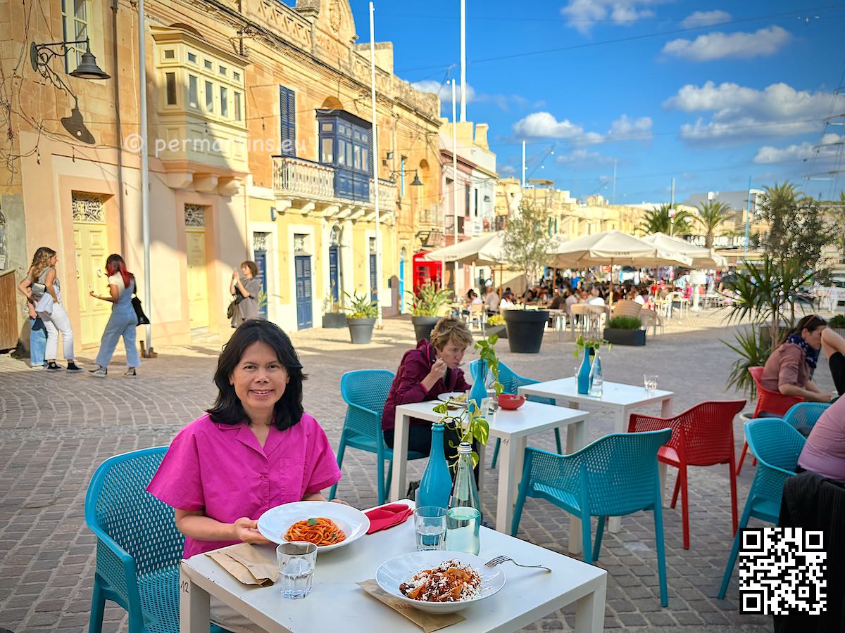 Malta Marsaxlokk woman eating pasta at Pastaus Lab restaurant