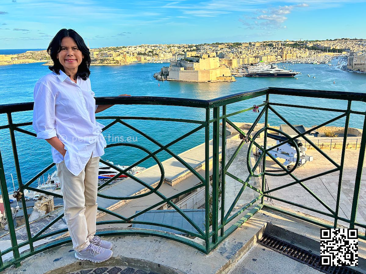 Malta Valletta woman enjoying the view from Upper Barrakka over the harbour.