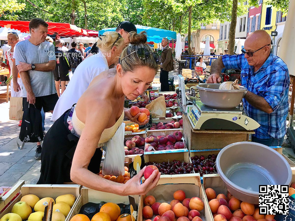 France Carcassonne woman picking fruit at Place Carnot Marché