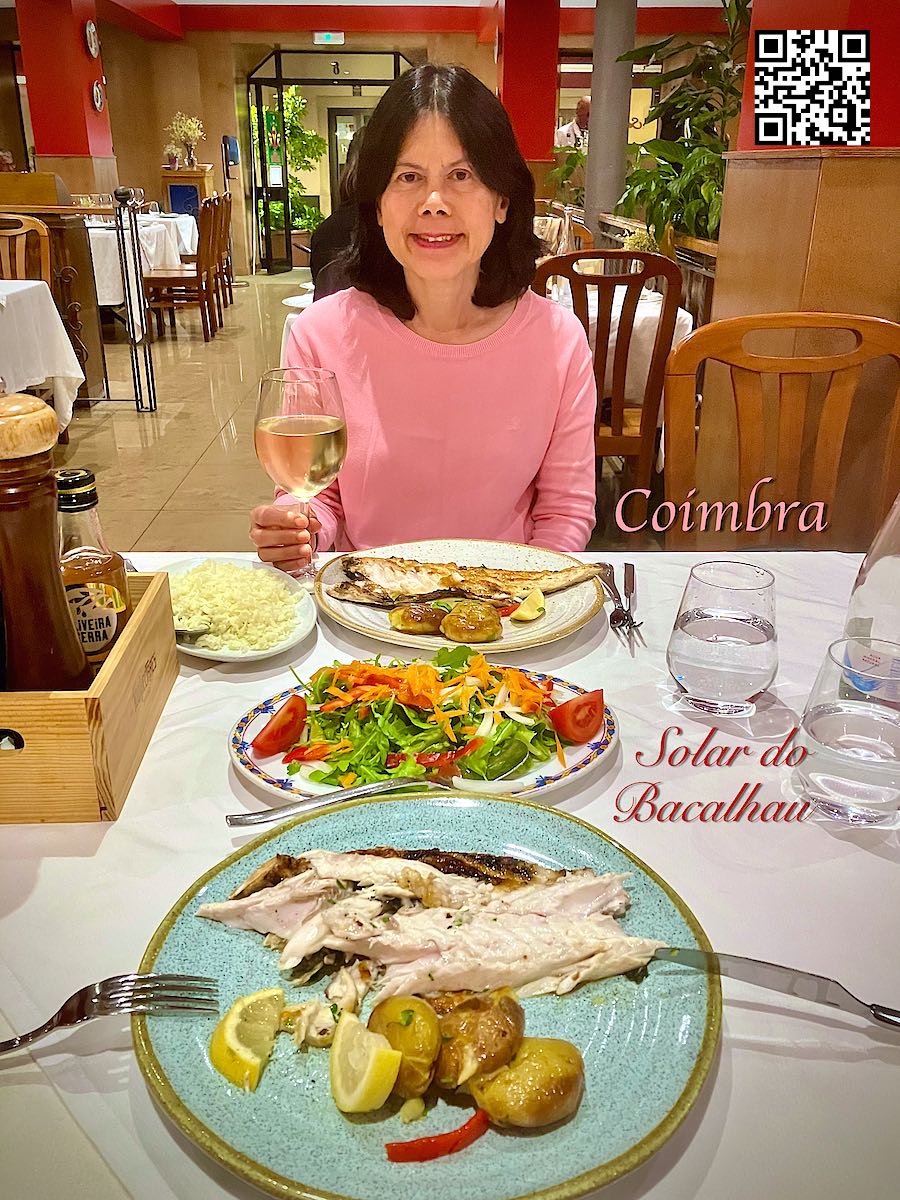Portugal Coimbra woman eating fish at Restaurante Solar do Bacalhau.