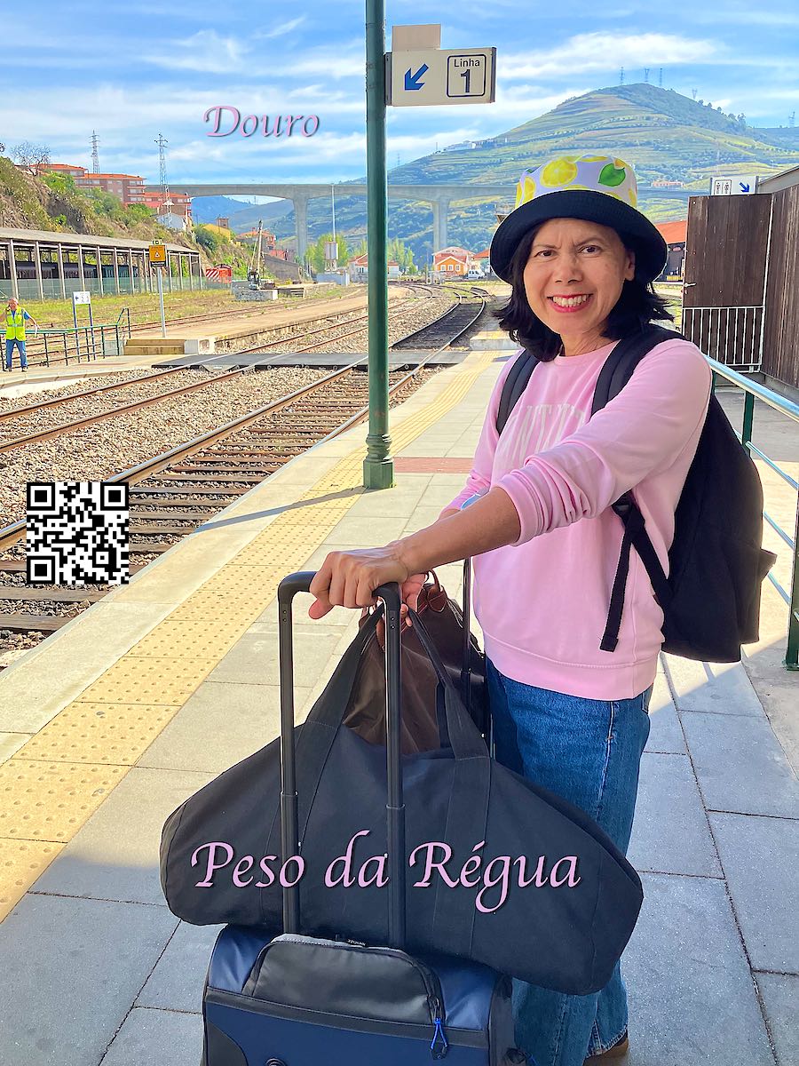 Portugal Douro woman with luggage waiting for a train at Peso da Régua station