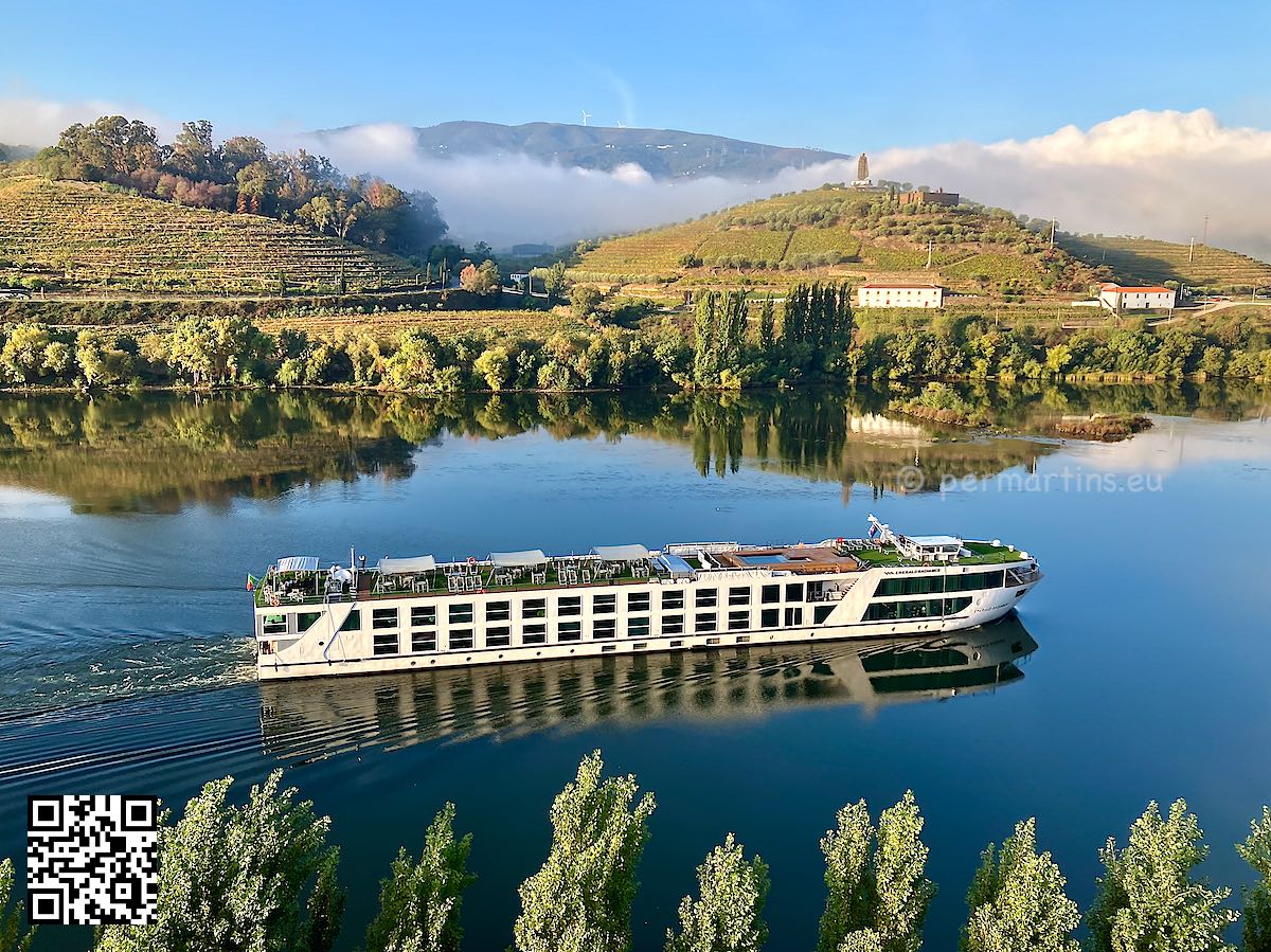 Portugal Douro at Peso da Régua tourist boat on the river big Sandeman figure the background