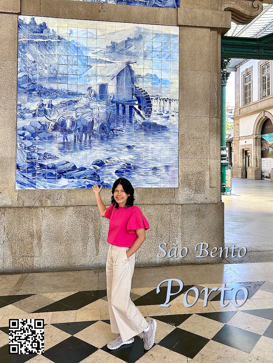 Portugal Porto São Bento train station with beautiful tiles woman standing in front tiles with oxen