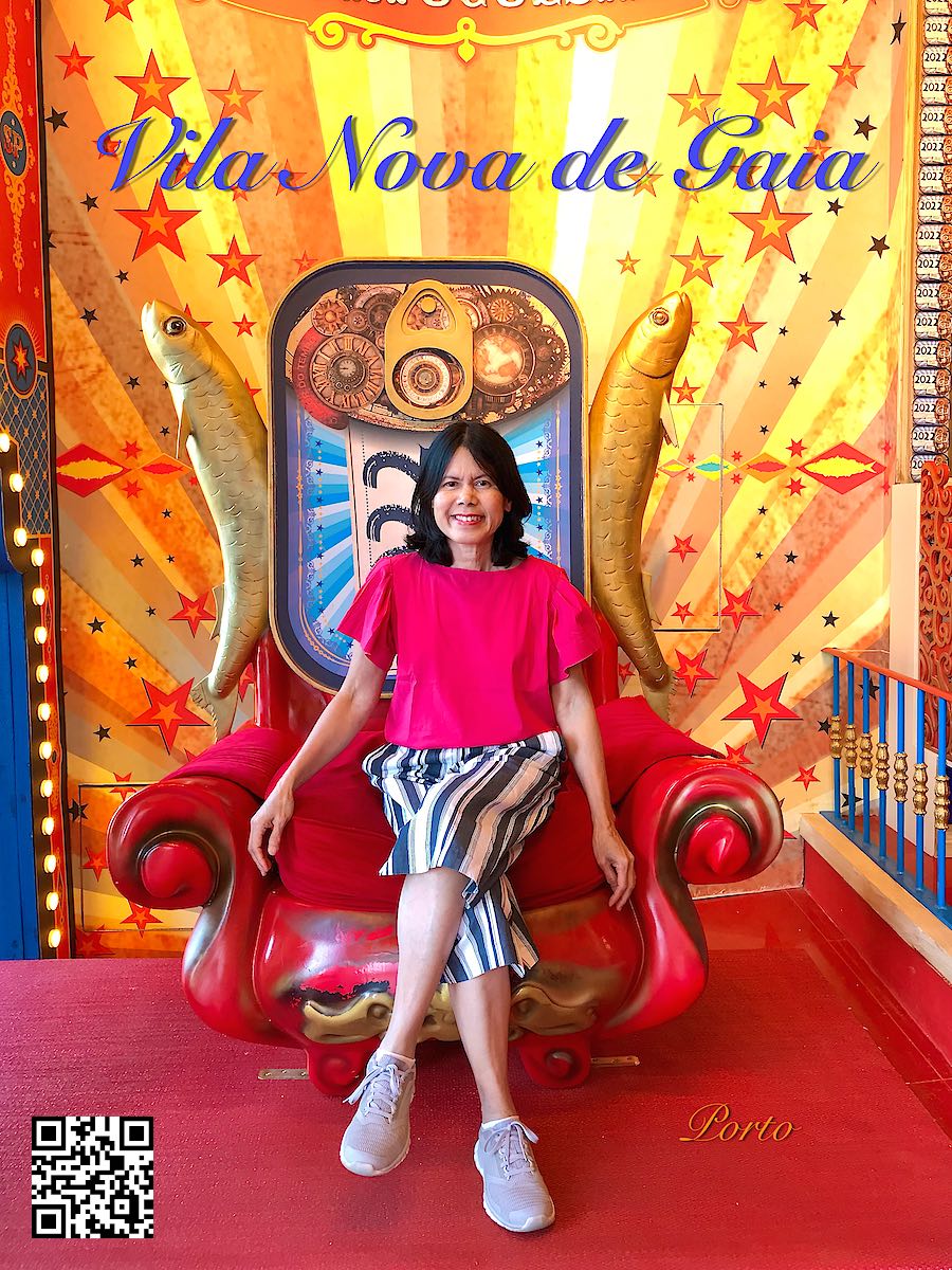 Portugal Porto Vila Nova de Gaia Sardinha Portuguesa Sardines museum woman sitting in chair witk huge sardines on the side