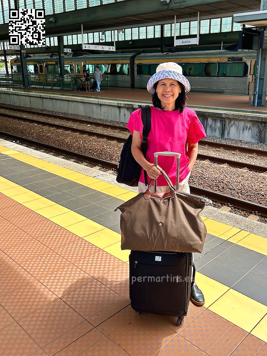 Portugal Aveiro woman with luggage at the train station